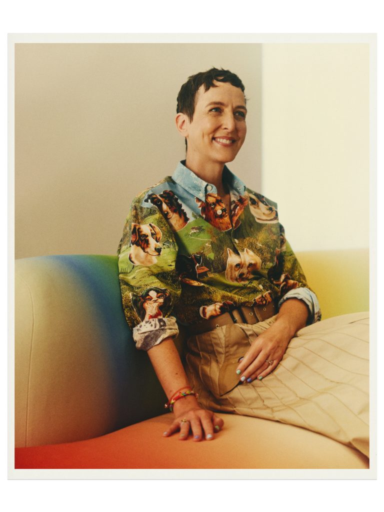 Sarah-andelman-portrait-puppy-print-shirt-brown-skirt-colourful-sofa
